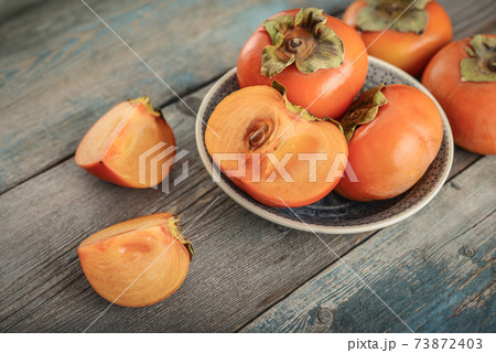 Fresh organic ripe Persimmon fruits 73872403