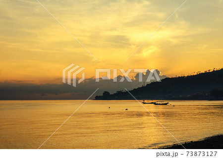 Views of the beach and the ocean at sunrise. 73873127