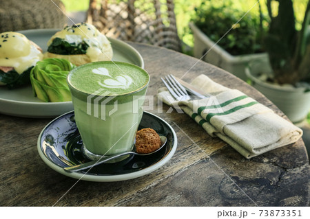 Matcha latte with latte art on top Matcha latte with latte art on top 73873351
