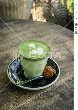 Matcha latte with latte art on top 73873353