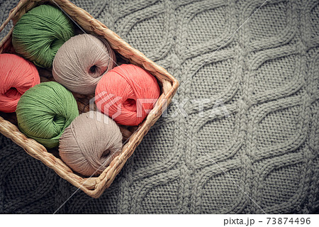 Colored yarn balls in rustic wicker basket Colored yarn balls in rustic wicker basket 73874496