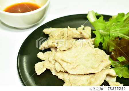 boiled pork slice arranging on plate dipping spicy sauce 73875252