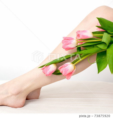 Woman's legs with tulips flowers Woman's legs with tulips flowers 73875920
