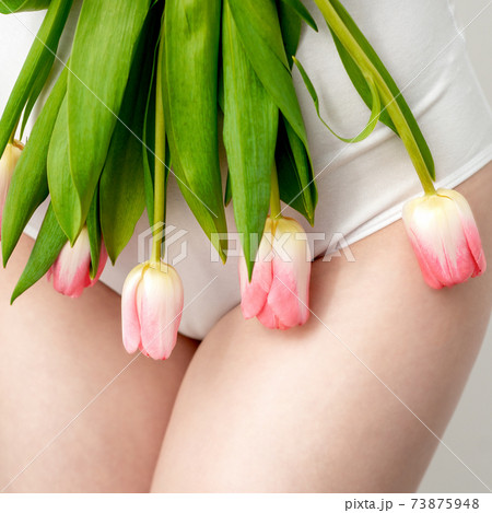 Woman's bikini area with tulips 73875948