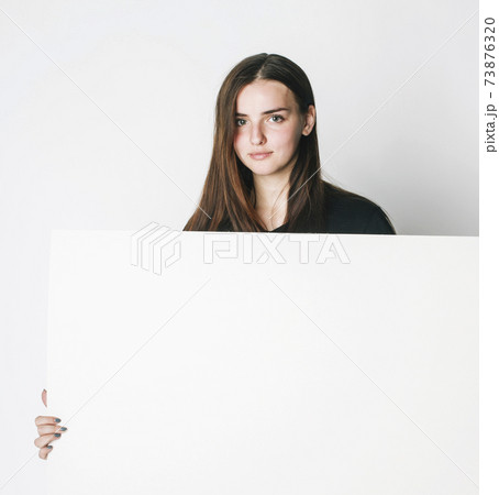 young pretty brunette girl with placard shit copyspace on white background wearing business costume student young pretty brunette girl with placard shit copyspace on white background wearing business costume student 73876320