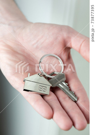 Estate agent giving house keys to client for new home, contract real estate for mortgage approved, focus on keys, business, financial, Estate concept Estate agent giving house keys to client for new home, contract real estate for mortgage approved, focus on keys, business, financial, Estate concept 73877395