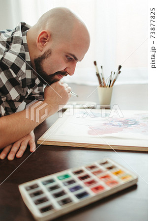Man drawing laying on the floor of design studio Man drawing laying on the floor of design studio 73877825