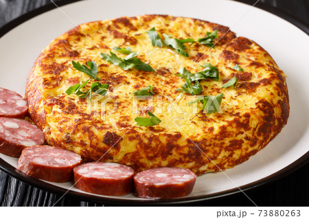 LuxembourgTierteg mashed potato pancakes with bacon and sauerkraut, served with sausages close-up in a plate. Horizontal LuxembourgTierteg mashed potato pancakes with bacon and sauerkraut, served with sausages close-up in a plate. Horizontal 73880263