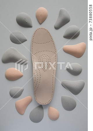 The process of manufacturing individual orthopedic insoles for people with foot diseases, flat feet. Close-up of the insole and accessories for it. 73880558