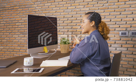 Smiling African American business woman, black person working from home with blank screen computer to meet colleagues in conference call in quarantine in corona virus pandemic. Lifestyle 73881042