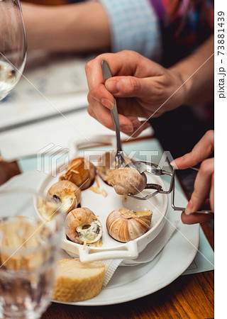 Snails with herbs butter, in traditional ceramic pan bread and s Snails with herbs butter, in traditional ceramic pan bread and s 73881439