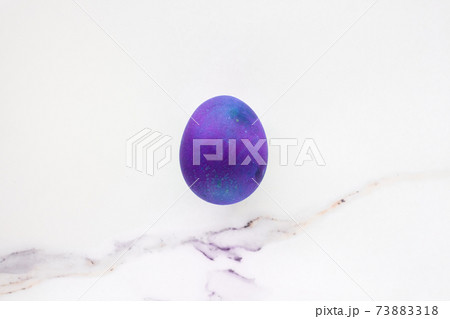 Minimal easter concept of purple eggs. Stylish Easter purple on white marble background. The flat lay fashionable easter. Happy easter card with copy space for text Minimal easter concept of purple eggs. Stylish Easter purple on white marble background. The flat lay fashionable easter. Happy easter card with copy space for text 73883318