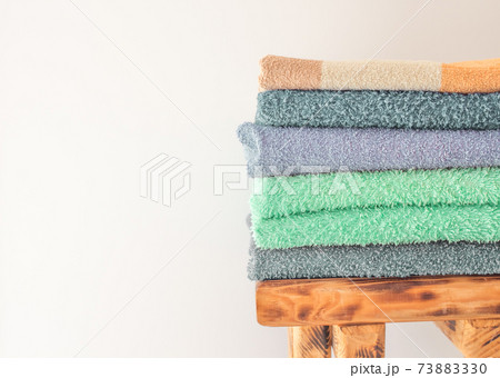 Lots of colorful bath towels stacked on each other. Isolated cotton towels for hotels, home, bathroom, kitchen 73883330
