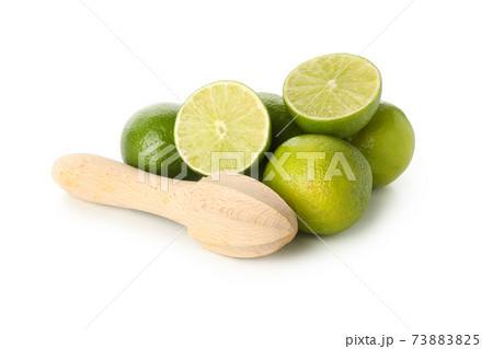Ripe lime and wooden juicer isolated on white background Ripe lime and wooden juicer isolated on white background 73883825