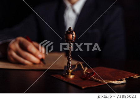 Notary's public pen and stamp on testament and last will. Person in office approved documents Notary's public pen and stamp on testament and last will. Person in office approved documents 73885023