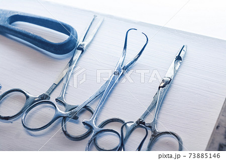 Old surgical metal medical devices on wooden table Old surgical metal medical devices on wooden table 73885146