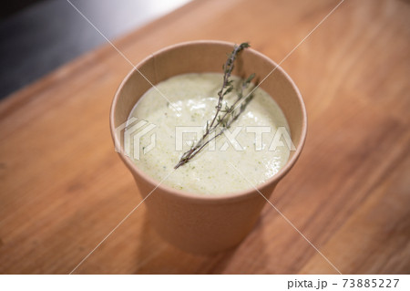 closeup of cream soup in kraft paper food container for delivery closeup of cream soup in kraft paper food container for delivery 73885227