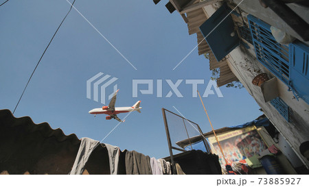 The plane lands low over the slums of the city of Mumbai. The plane lands low over the slums of the city of Mumbai. 73885927
