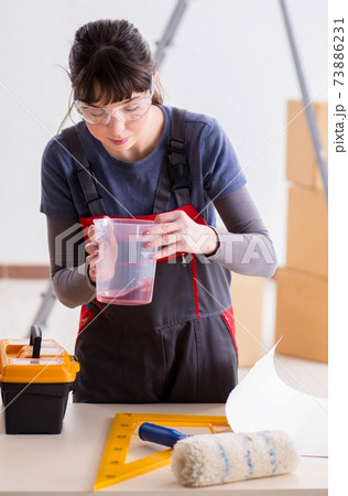 Woman preparing for wallpaper work 73886231