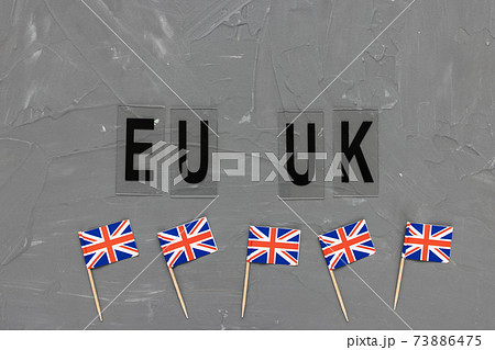 United Kingdom flags and text EU UK on gray background 73886475