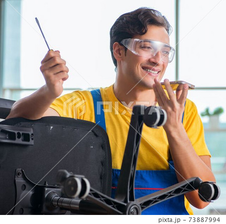 Furniture repairman working on repairing the chair 73887994