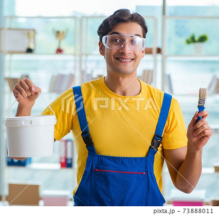 Painter with bucket of paint in workshop Painter with bucket of paint in workshop 73888011