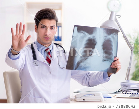 Young handsome doctor working in hospital room 73888642