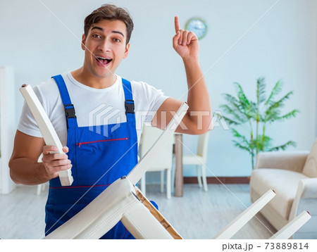 Repairman repairing broken chair at home 73889814