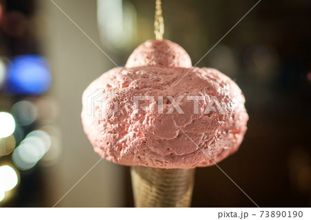 Icecream cone artificial hanging on display of cafe store Venchi in Milan, Italy. Ice cream decorative background. Icecream cone artificial hanging on display of cafe store Venchi in Milan, Italy. Ice cream decorative background. 73890190