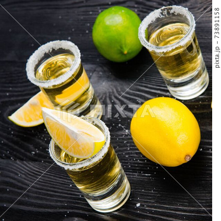Tequila drink served in glasses with lime and salt 73891158
