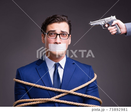 Businessman taken hostage and tied up with rope Businessman taken hostage and tied up with rope 73892981