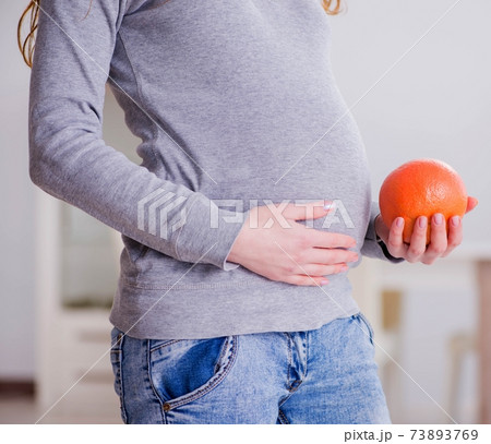 Pregnant woman touching her belly Pregnant woman touching her belly 73893769