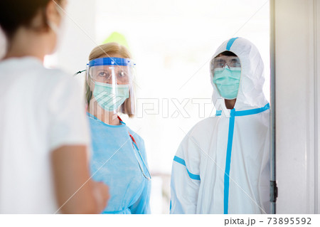 Doctor examining sick patient at home. 73895592