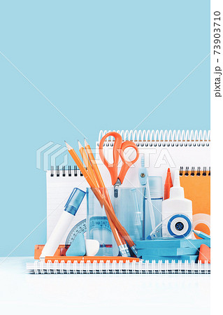 Group of office and school yellow orange and light blue stationery on desk Group of office and school yellow orange and light blue stationery on desk 73903710