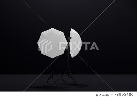 Photography studio lighting stand with flash and umbrella isolated on black Photography studio lighting stand with flash and umbrella isolated on black 73905480