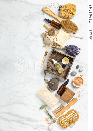 Flat lay composition with lavender flowers and natural cosmetic products on white marble background Flat lay composition with lavender flowers and natural cosmetic products on white marble background 73905598
