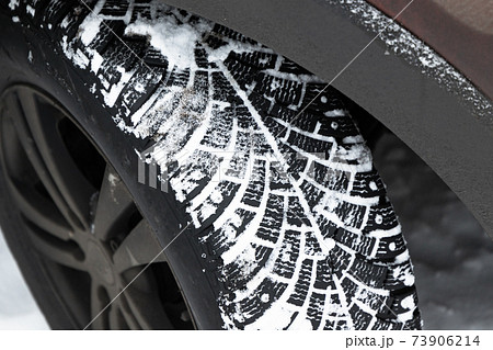 SUV car wheel. Snow tire with metal studs SUV car wheel. Snow tire with metal studs 73906214