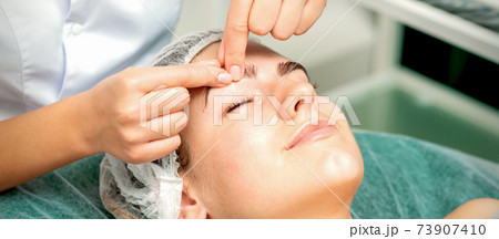 Beautician make massage on eyebrow Beautician make massage on eyebrow 73907410