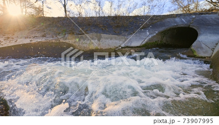 Large sewage tunnel with filth flowing out Large sewage tunnel with filth flowing out 73907995
