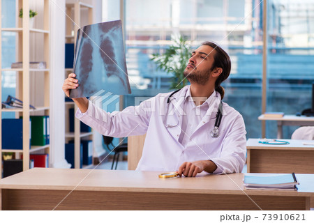 Young male doctor radiologist working in the clinic Young male doctor radiologist working in the clinic 73910621