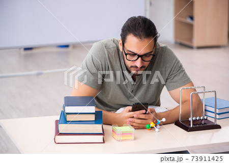 Young male student preparing for exams in the classroom 73911425