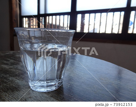 テーブルの上にある水の入ったガラスコップ テーブルの上にある水の入ったガラスコップ 73912153