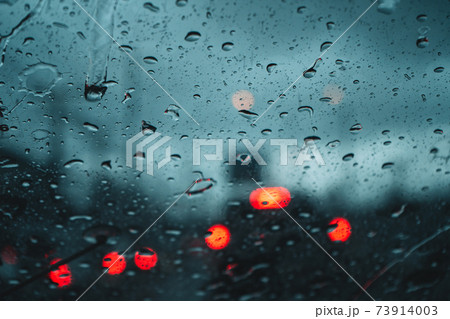 Water droplets on the glass in the evening rain blur Water droplets on the glass in the evening rain blur 73914003