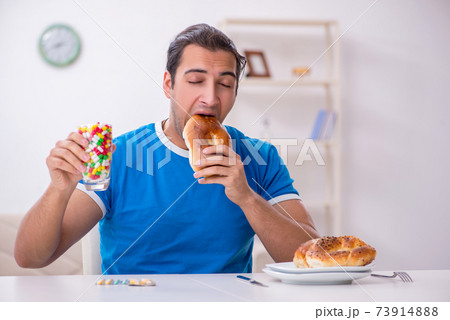 Young hungry man in dieting concept Young hungry man in dieting concept 73914888