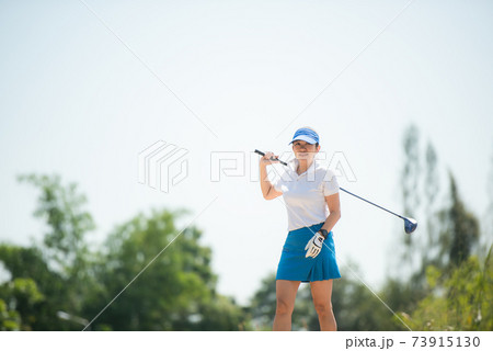 Golfer sport course golf ball fairway. People lifestyle woman relax after swing golf ball on the green 73915130