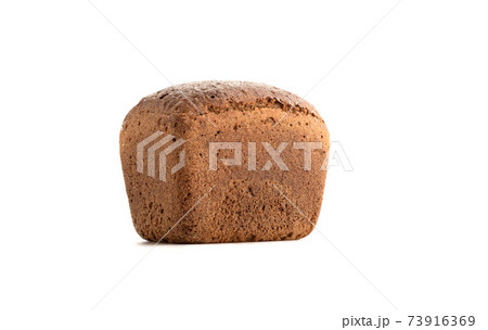 Whole loaf of wheat rye bread on a white plate. Whole loaf of wheat rye bread on a white plate. 73916369
