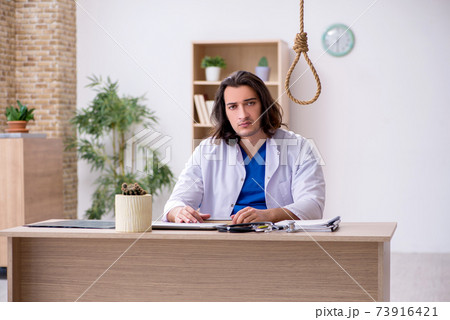 Young male doctor committing suicide in the hospital 73916421