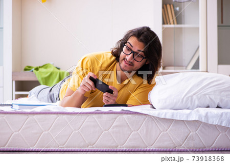 Young male student preparing for exams at home Young male student preparing for exams at home 73918368