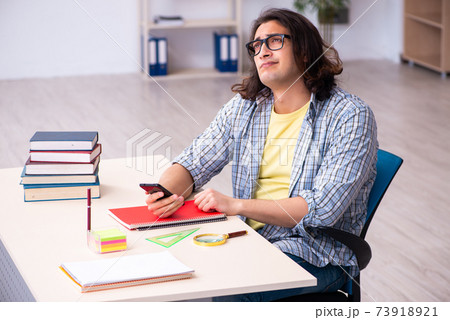Young male student preparing for exams 73918921
