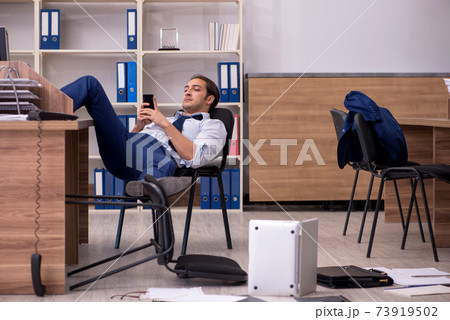 Young male businessman employee unhappy with his work Young male businessman employee unhappy with his work 73919502